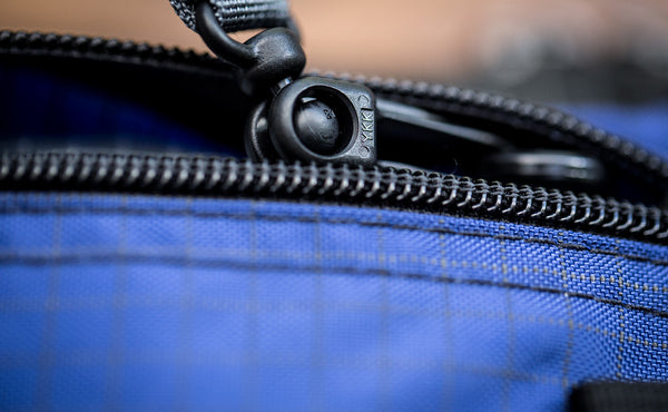 A close shot of a snaphook attached to an o-ring.
